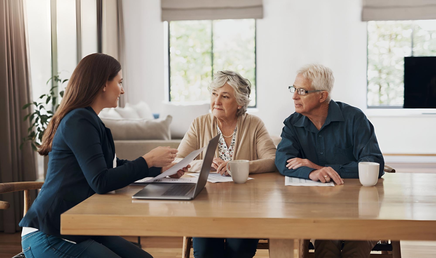 Care coordinator reviewing a home care plan with a senior couple